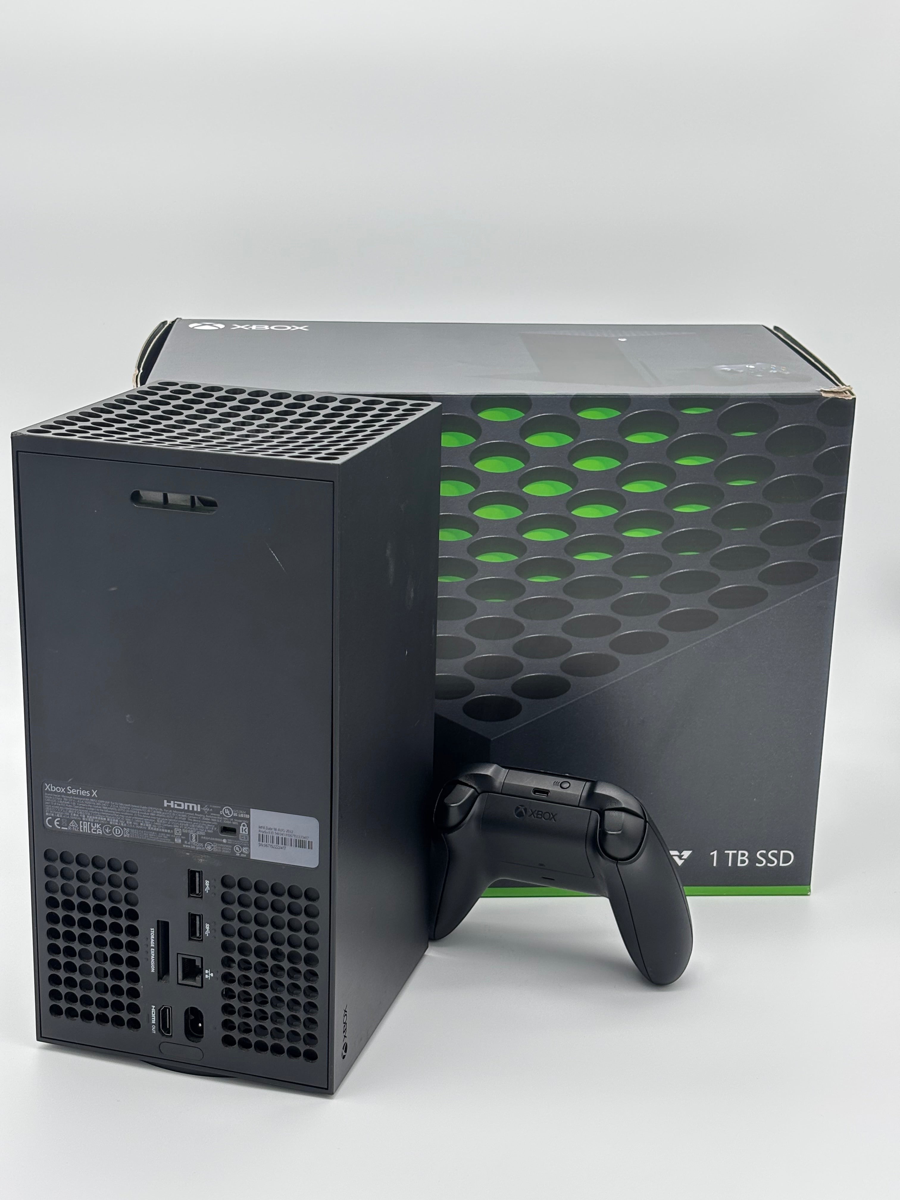 Mobile2fix pre-owned black XBOX Series X console and controller with original box, showing minor outer case wear.
